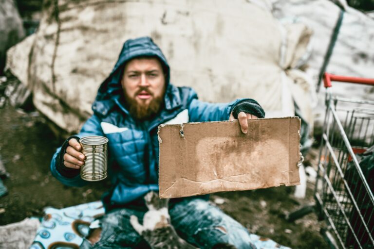Homeless Man Holding Can Sign