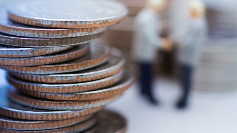 Coins Stacked Businessmen Shaking Hands