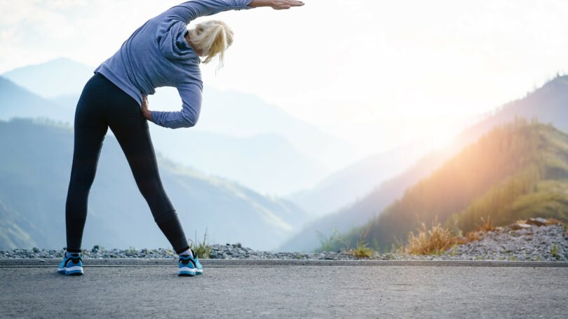 Woman Exercising Outdoors Stretching