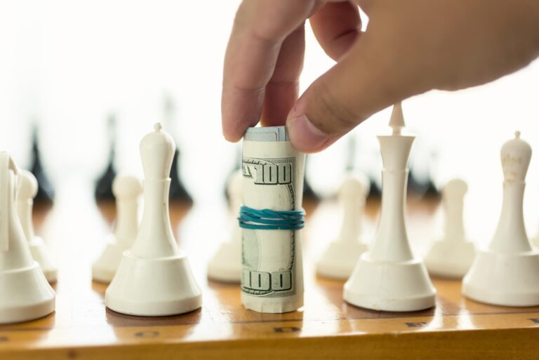Money Moves Hand Playing Chess Cash