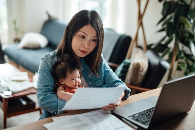 Woman With Child Reading Paper Statement