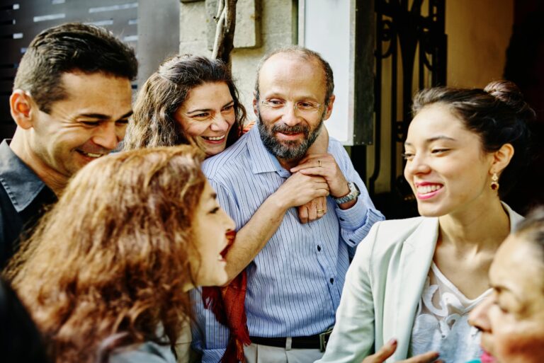 Smiling Multi Generational Family Talking And Laughing During Party