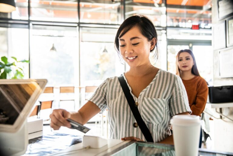 Woman Using Credit Card Coffee Shop