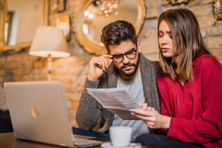 Young Couple Examining Bill Computer